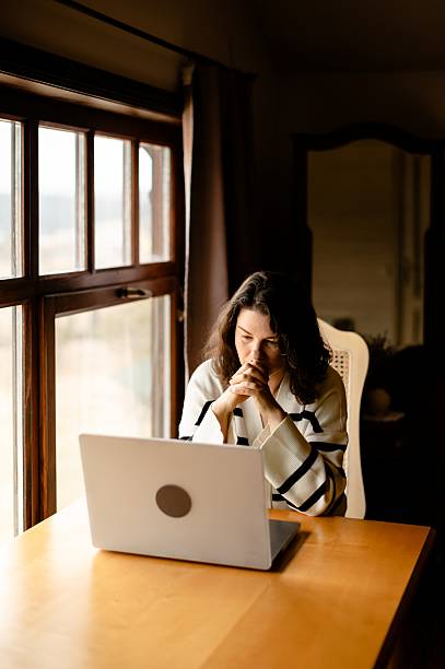 istock Woman communicates using a laptop with various emotional expressions in a cozy indoor setting 2226638930