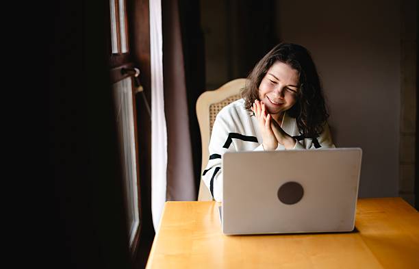 istock Woman expresses various emotional states while communicating online during a cozy indoor moment 2226638956