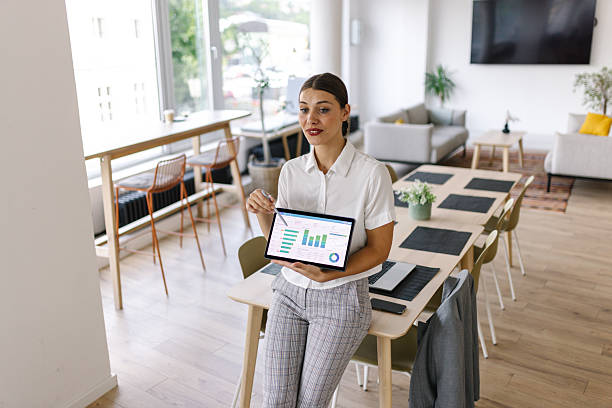 istock Professional Woman Presenting Data in a Modern Office 2226639056