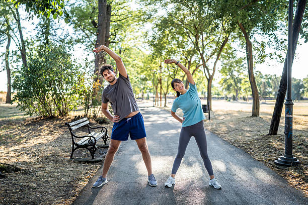 istock Young couple stretching in the park before exercising 2226640130