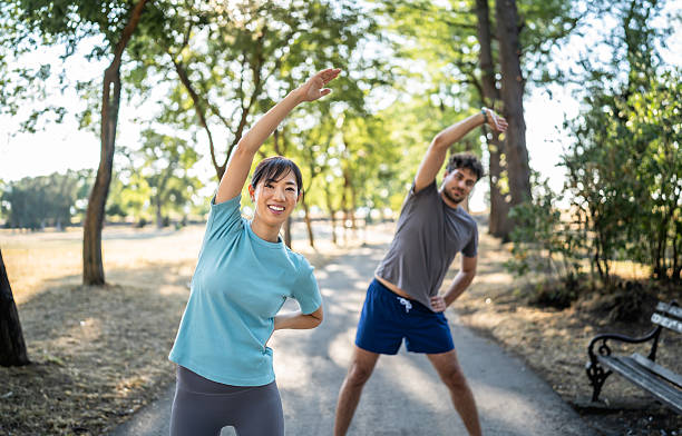 istock Young woman stretching in the park before exercising 2226640378