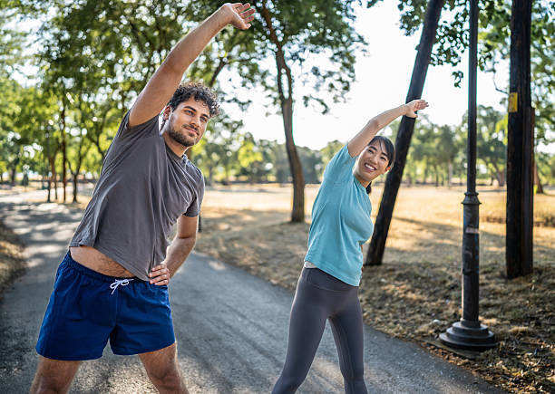 istock Young couple stretching in the park before exercising 2226640652