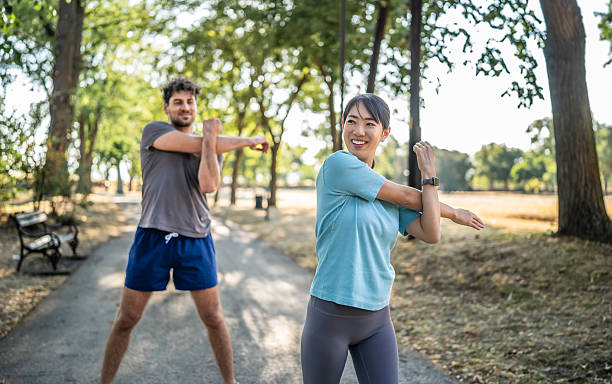 istock Young woman stretching arms before exercising in the park 2226641937