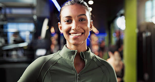 istock Portrait, healthy and woman with smile in gym, confident and commitment to training routine or workout. Happy, athlete and Indian person with pride for wellness, sportswear or break in fitness center 2226642489