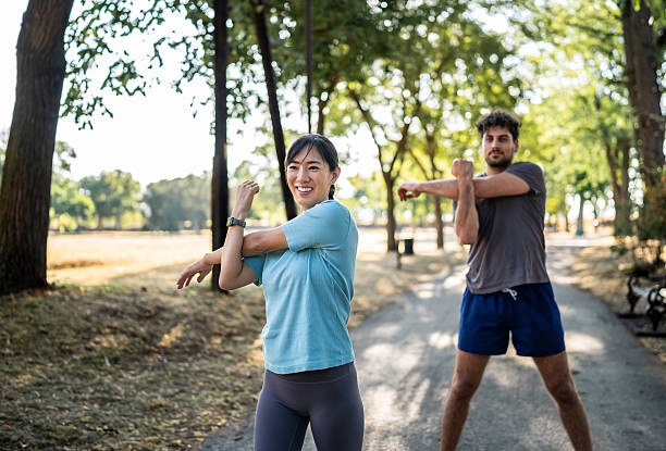 istock Young woman stretching arms before exercising in the park 2226642539