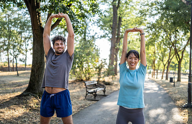 istock Young couple stretching in the park before exercising 2226642623