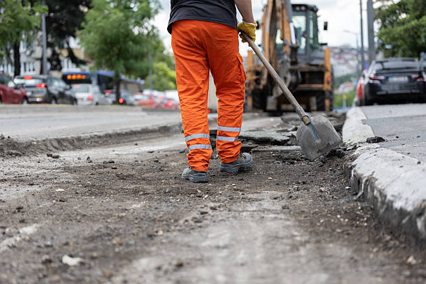 istock Construction worker repairs road on city street during daytime 2226642783