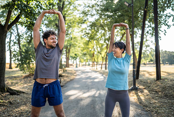 istock Young couple stretching in the park before exercising 2226642877