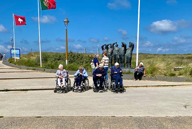 Egmond aan Zee,  Netherlands - July 22, 2025.  Seniors enjoy a visit at the Beach of the monumental City.