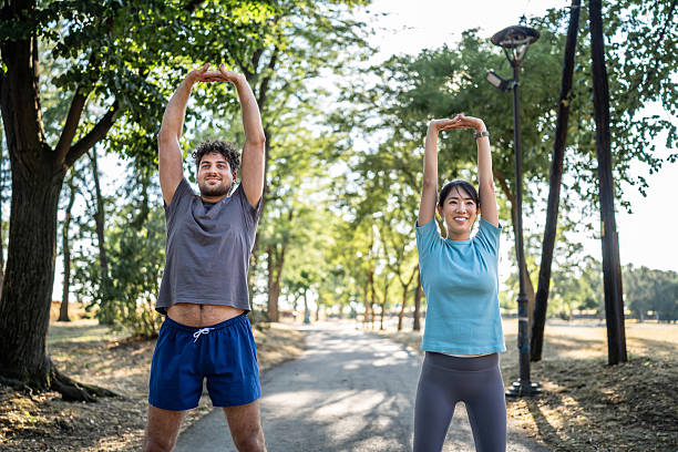 istock Young couple stretching in the park before exercising 2226643440