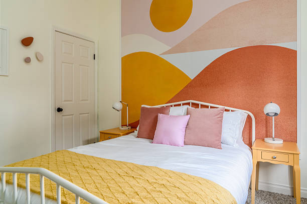 Desert modern boho chic bedroom interior with bed, side tables, lamps