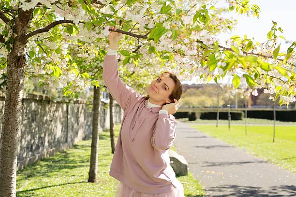 istock A Joyful Woman Enjoying the Beautiful Spring Blossoms in a Blooming Park Setting 2226648762
