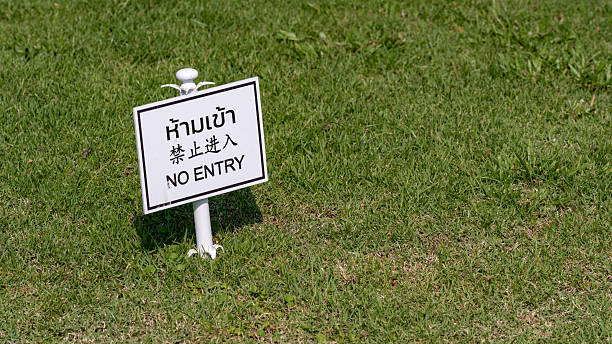 istock Multilingual no entry sign on green grass lawn 2226651094