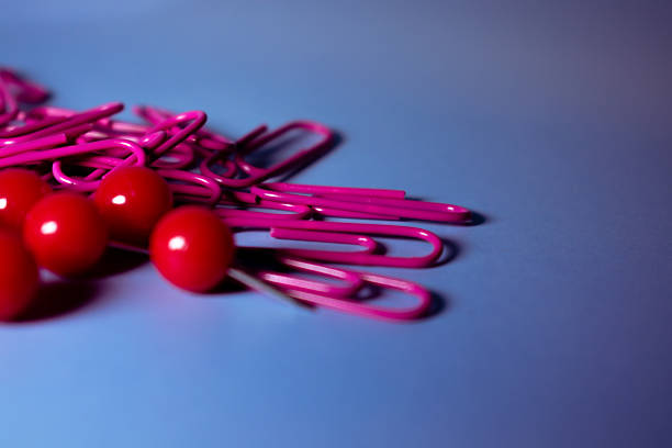 Three colorful Jumbo Paperclips attached to a blank white Index Card. Clipping Path. Clone out the paperclips you don't want. Index card is over 8\