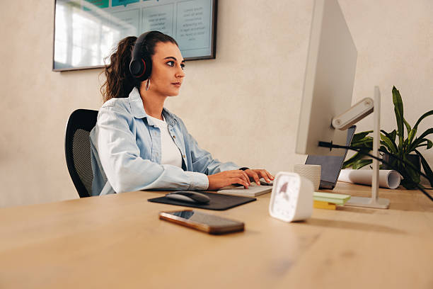 istock Businesswoman working at desk while using a computer in an office 2226655399