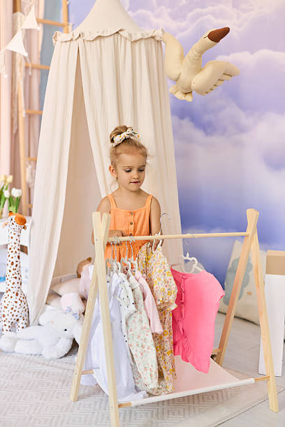 istock Little child girl choosing her clothes. 2226656239