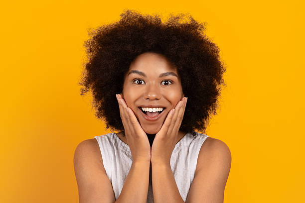 istock Surprised and delighted young black woman touching face with hands 2226656461