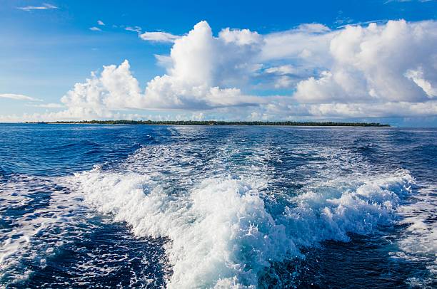 Watching perfect waves from the roof of an old boat anchored next to a surfers paradise tropical island.