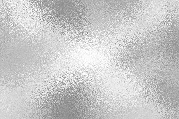 istock gray foil glass texture background. Abstract gradient bright light reflection and shiny rough texture surface. The light softly scatters, creating a shimmering effect with varying tones of silver gray 2226657446