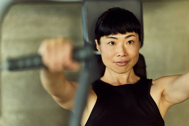 istock Fit Woman Using Gym Equipment for Strength Training Focused and Determined 2226660109