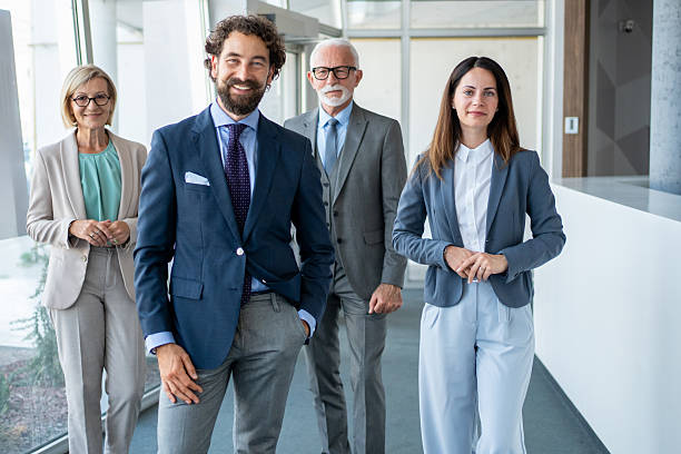 istock Smiling business team standing in modern office hallway 2226663342