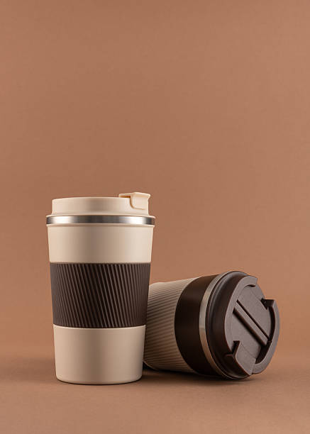Reusable coffee  thermo cup, mockup on warm beige background