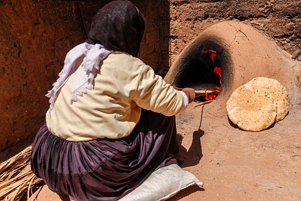 istock Moroccan woman making bread - khubz 2226667663