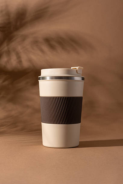 istock Reusable coffee  thermo cup, mockup on warm beige background with natural shadows 2226668156