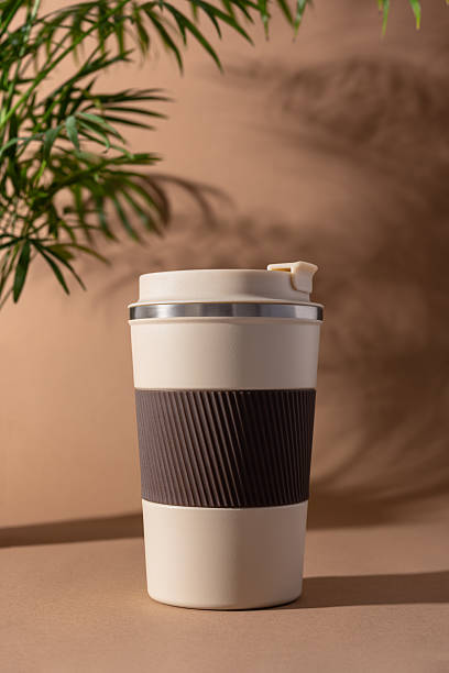 istock Reusable coffee  thermo cup, mockup on warm beige background with natural shadows 2226668203