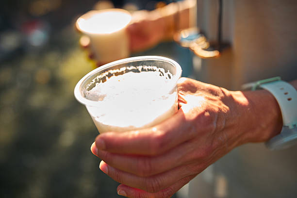 istock Person holding beer cup outdoors on a sunny day. 2226671507