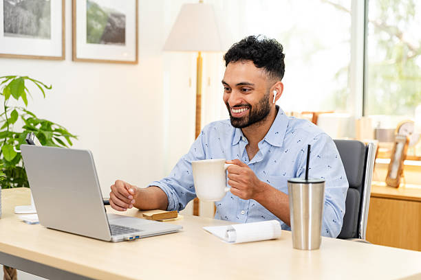 istock Smiling Man Using Laptop in Home Office Video Call 2226673733