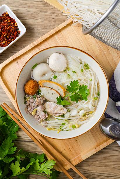 istock Clear pork noodle soup with thin rice noodles in ceramic bowl with chopsticks 2226675152