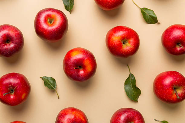 istock Many red apples on colored background, top view. Autumn pattern with fresh apple above view 2226675684