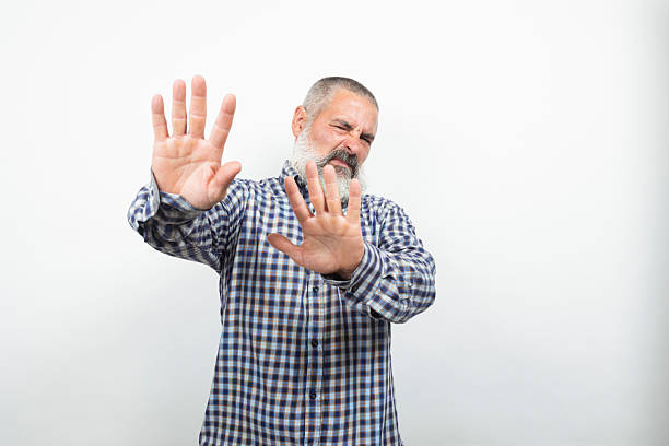 istock Mature man showing stop sign with both hands and disgusted face expression 2226677803