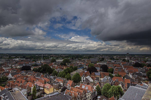 Panorama view over the city Deventer and the IJssel under a rain shower of hail in the summer season