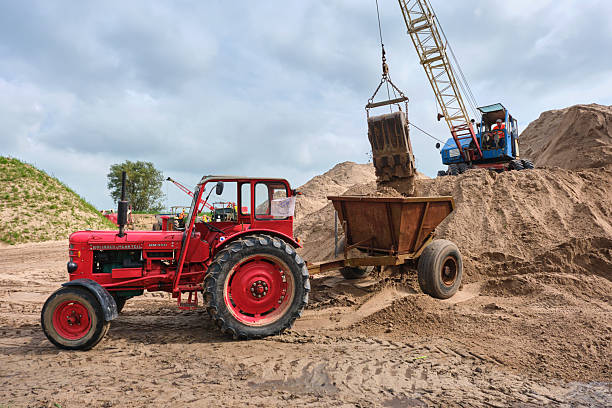 September 7, 2024 - Oudkerk-Netherlands: Vintage Fuchs dragline excavator loading a dump truck during a historic earthmoving weekend at a sand pit, highlighting classic civil engineering.