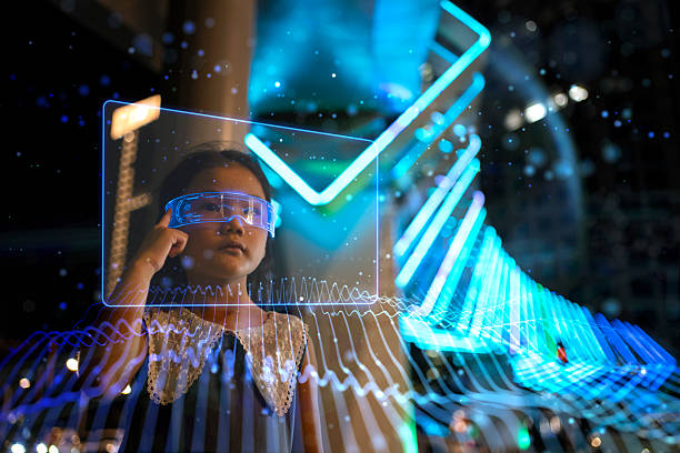 istock Cute little girl using glowing glasses looking at virtual screen 2226680907