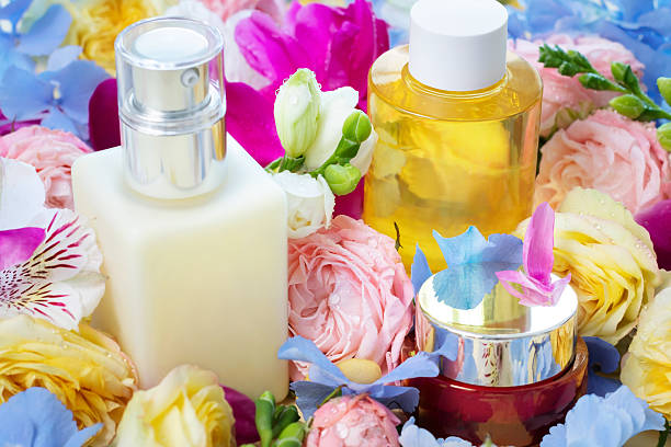 beauty treatment set: body oil, moisturizing cream, face cream, mixed fresh flowers