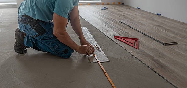 istock Floating floor work. The worker measuring the board of vinyl plank before shortening. 2226682449