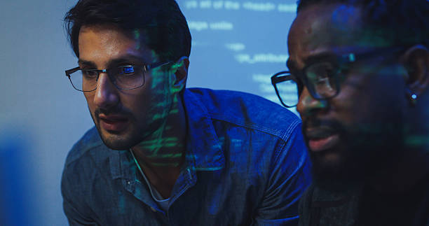 istock Closeup Black and Hispanic male engineers programmers work together collaborate discuss software development strategies in tech office late into the night. Software developer, artificial intelligence. 2226685130