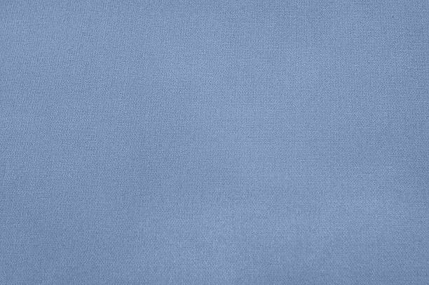 Close-up view of a textured, blue fabric, showcasing its detailed weave and subtle pattern.
