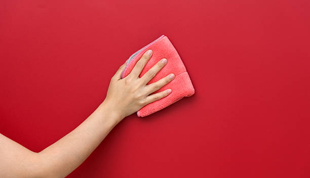 istock Woman hand cleaning red wall with rag 2226692231