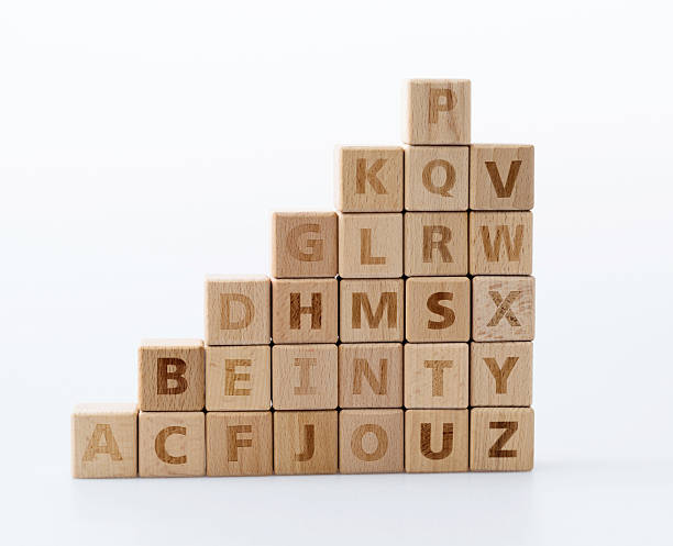 Wooden alphabet blocks on white background.