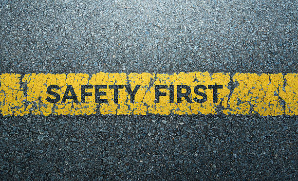 istock 'Safety first' text with yellow sign on the asphalt road 2226692372