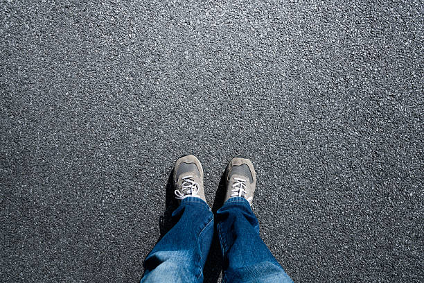 istock Looking down at shoes on the road 2226692626