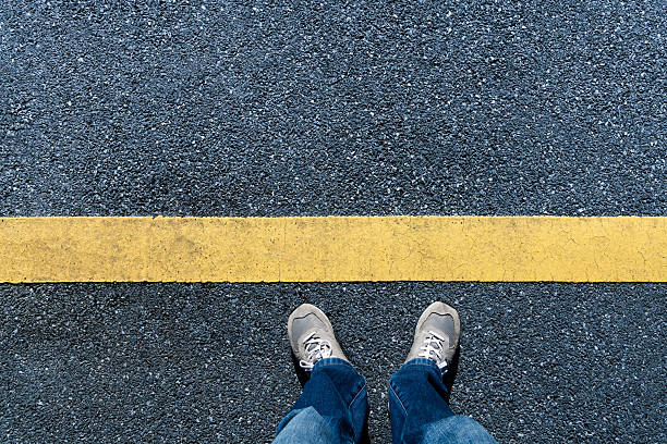 istock Top view of man standing next in yellow line 2226692660