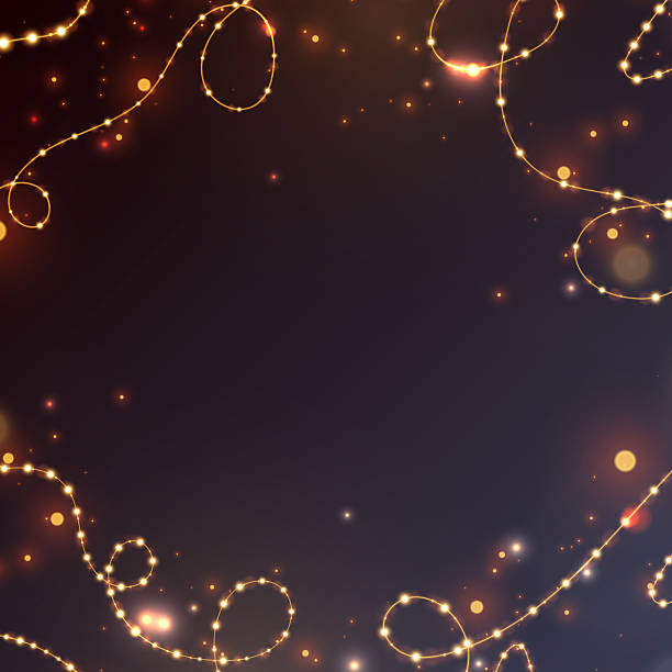 istock Garland with golden sparkles and bright highlights on a dark background in a frame style. 2226694065