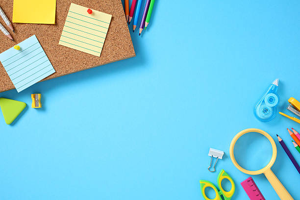 istock Flat lay colorful school supplies surrounding a corkboard with sticky notes, arranged on a bright blue background. Ideal for education, planning, office, and organizational themes 2226698754