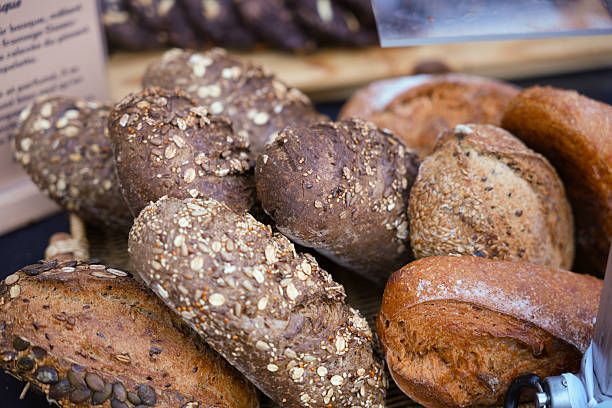 istock Assorted multigrain and whole wheat bread loaves displayed at bakery market 2226699912