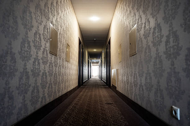 istock Dimly Lit Hotel Corridor with Patterned Carpet and Wallpaper 2226701542